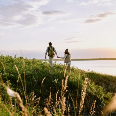 Holding hand of girlfriend while hiking hills